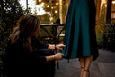 Woman adjusting silk cocktail dress sleeve