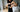 Hands adjusting undergarment under cut-out dress