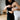 Hands adjusting undergarment under cut-out dress