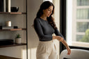 Woman adjusting charcoal long sleeve bodysuit