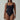 Woman modeling a black sustainable one-piece bodysuit with square neckline and high-cut legs