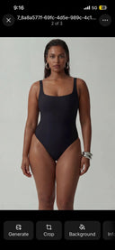 Woman modeling a black sustainable one-piece bodysuit with square neckline and high-cut legs