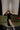 Front view of the Room 24 007 black maxi dress with a high neckline, fitted long sleeves, integrated gloves and thigh-high split.