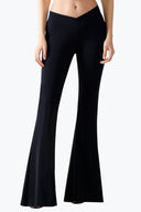 Front view of the Room 24 Gia trousers with a V-shaped waistband, sculpted fit and dramatic flared legs.