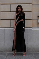 Front view of the Room 24 Verper black velvet maxi dress with one long sleeve, sweeping mesh cut-outs and a thigh-high split.