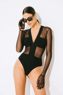 Side view of the Room 24 Maria black bodysuit showing its sheer waist panel, fitted sleeve and high-cut leg.