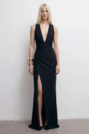 Front view of the Room 24 Silvy black maxi dress with a deep plunge neckline, draped wrap waist and centre slit.