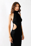 Side view of the Room 24 Camilla black maxi dress highlighting its curved waist cut-outs and sculpted full-length silhouette.