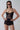 Front view of the Room 24 Lumi black sequin lace bodysuit with slim straps, structured cups and a sheer corset-style waist.