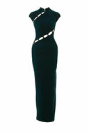 Close-up of the Room 24 Isabel emerald dress showing its plush velvet texture, structured high neckline and diagonal cut-out detailing.