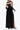 Back view of woman in long black velvet dress with mesh sleeves and high slit
