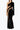 Front view of the Room 24 Verper black velvet maxi dress with one long sleeve, sweeping mesh cut-outs and a thigh-high split.