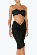 Side view of the Room 24 Mia midi skirt highlighting its gathered construction and draped hem.