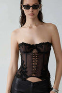 Front view of the Room 24 Selma corset with sheer tulle, underwired cups, lace appliqué and centre-front lacing.