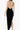 Back view of the Room 24 Anita black maxi dress highlighting its dramatic low open back and high side split.