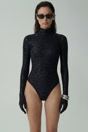Front view of the Room 24 Jane black leopard bodysuit with a high neckline, long sleeves and tonal animal texture.