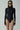 Front view of the Room 24 Jane black leopard bodysuit with a high neckline, long sleeves and tonal animal texture.