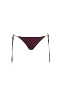 Maroon bikini bottom with gold chain side ties on white background