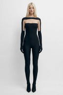 Front view of the Room 24 Janet black catsuit with a boat neckline, sheer illusion-tulle panels and matching long gloves.