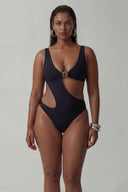 Front view of the Room 24 Leona one-piece swimsuit with a deep V-neckline, circular metal accent and asymmetric cut-out.