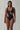 Front view of the Room 24 Leona one-piece swimsuit with a deep V-neckline, circular metal accent and asymmetric cut-out.