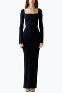 Front view of the Room 24 Bella black reversible maxi dress styled with a twisted V-neckline, curved waist cut-out and long sleeves.