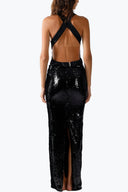 Back view of the Room 24 Ornella black sequin maxi dress highlighting its dramatic open back, halterneck and rear slit.