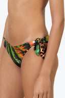Close-up of the Room 24 Stella bikini bottom showing its reversible construction, side knot and smooth stretch fabric.