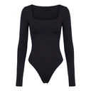 Side view of the Room 24 Jess black bodysuit showing its fitted sleeves, low back and body-contouring shape.