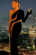 Front view of the Room 24 Verper black velvet maxi dress with one long sleeve, sweeping mesh cut-outs and a thigh-high split.