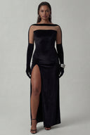 Front view of the Room 24 Samantha black velvet maxi dress with a sheer illusion neckline, fitted bodice and thigh-high split.