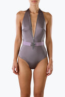 Front View- Zelda belted swimsuit by Room 24. A plunging halterneck, centre-front zip and statement waist belt create a sculpted resort silhouette.