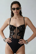 Front view of the Room 24 Lumi black sequin lace bodysuit with slim straps, structured cups and a sheer corset-style waist.