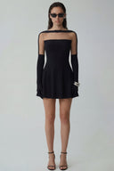Front view of the Room 24 Sola black mini dress with a sheer illusion neckline, long glove sleeves and flared A-line skirt.