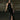 Woman in black sequin halter dress with thigh-high slit, wearing sunglasses and heels