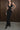 Side view of the Room 24 Kaya black maxi dress showing its layered waist bands, side cut-outs and body-contouring fit.