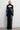 Front view of the Room 24 Talia black corset maxi dress with a mesh-panelled bodice, integrated gloves and thigh-high split.
