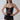 Woman modeling a black sequin mesh bodysuit with cut-out details, sunglasses, and bold jewelry.