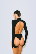 Back view of the Room 24 Jane black bodysuit highlighting its dramatic open back and sculpted thong silhouette.