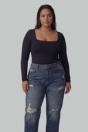Front view of the Room 24 Jess black long-sleeve bodysuit with a square neckline and sculpted close fit.