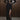 Woman wearing a black long sleeve dress with sheer bodice and thigh-high slit