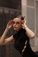 Side view of the Room 24 Lin black velvet dress highlighting its asymmetric cut-out detailing and sculpted mini silhouette.
