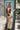 Front view of the Room 24 Alexa black one-piece swimsuit with a plunging halterneck, ruched panels and crossover cut-out straps.