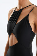 Side view of the Room 24 Alina black one-piece highlighting its curved waist cut-outs and high-cut leg.