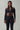 Front view of the Room 24 Anna black catsuit with a high collar, centre zip, shoulder cut-outs and strappy waist.