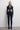 Front view of the Room 24 Anna black catsuit with a high collar, centre zip, shoulder cut-outs and strappy waist.