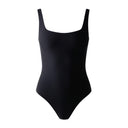 Close-up of the Room 24 Ariel black bodysuit showing the clean square neckline, wide straps and smooth stretch-fabric finish.