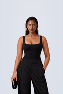 Front view of the Room 24 Ariel black sleeveless bodysuit with a square neckline, wide straps and sculpted close fit.