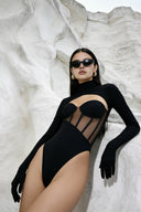 Side view of the Room 24 Ashanti black bodysuit showing its structured bust, sheer corset waist and sculpted fit.