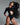 Side view of the Room 24 Selma black bodysuit highlighting its shoulder cut-outs, sculpting stretch fabric and high-cut leg.
